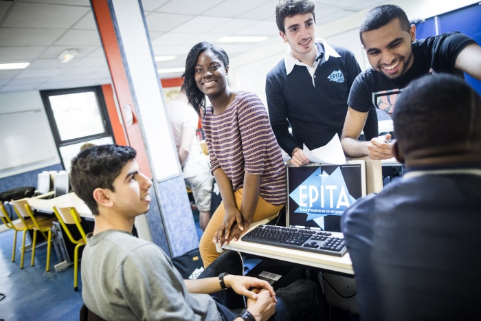 Etudiants riant autour d'un ordinateur